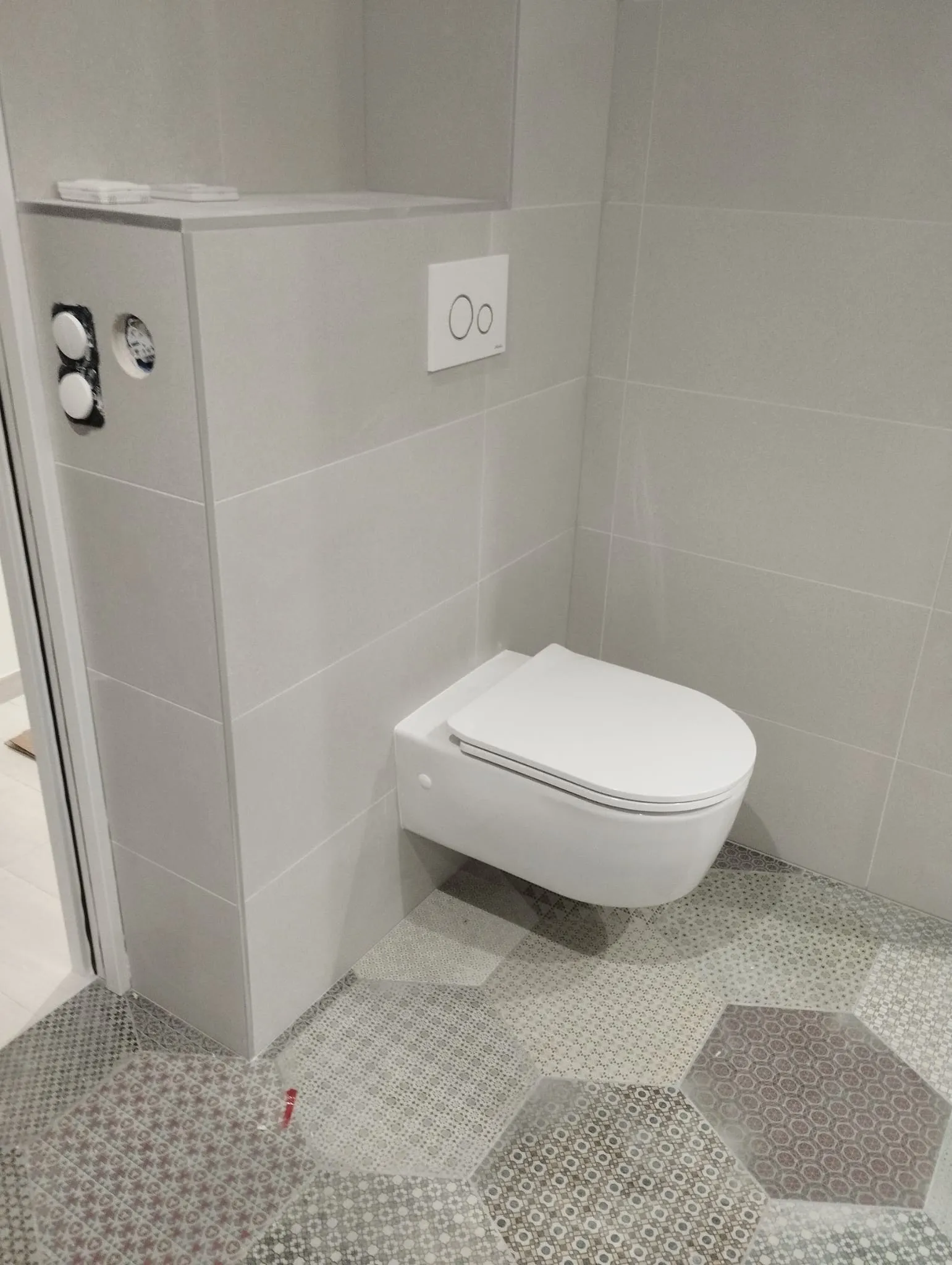 WC suspendu : coffrage carrelé et sol hexagonal